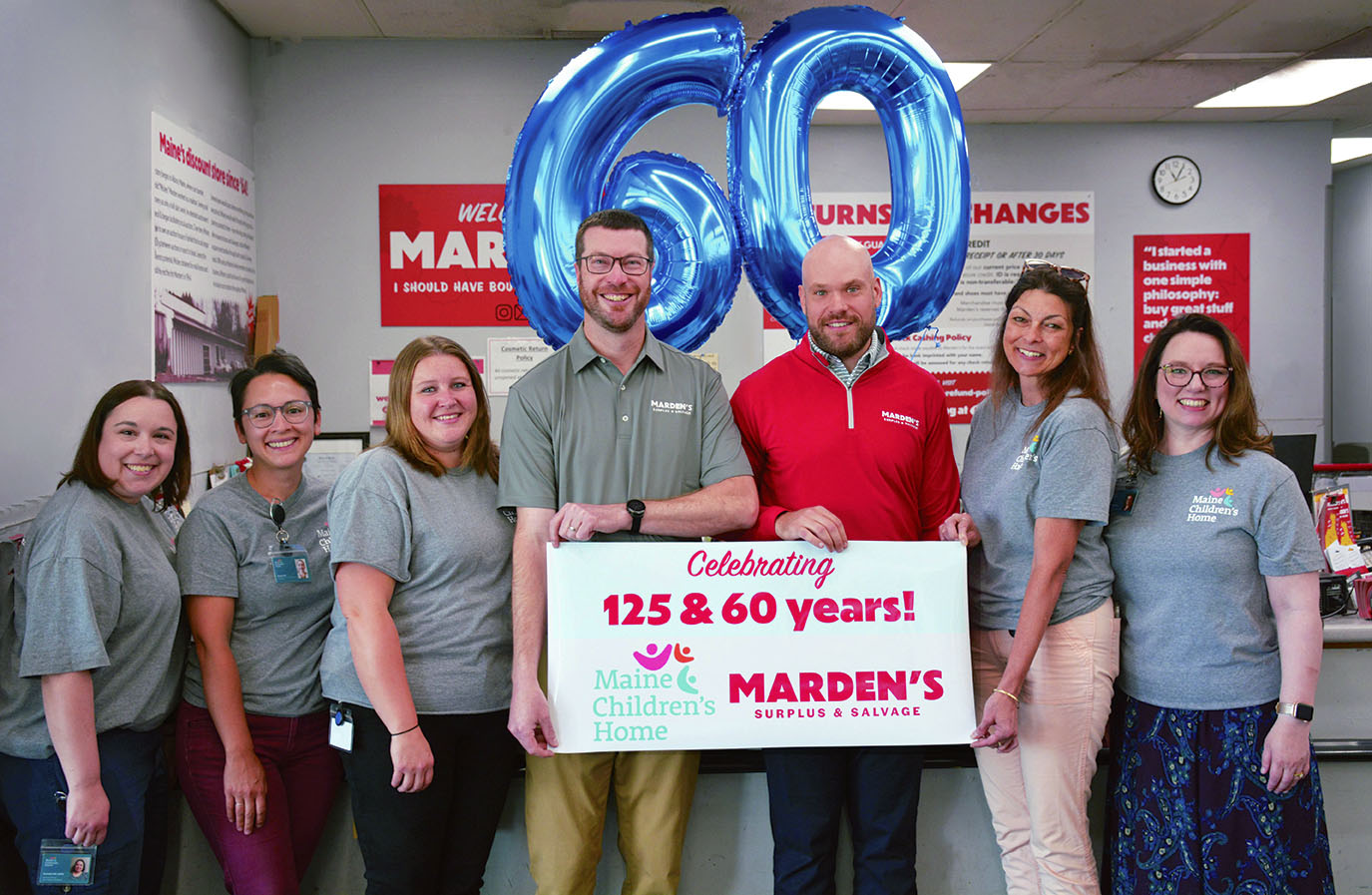 Directors of Maine Children's Home pose with Jake and Andrew Marden (center) during a celebration of their partnership and anniversaries.